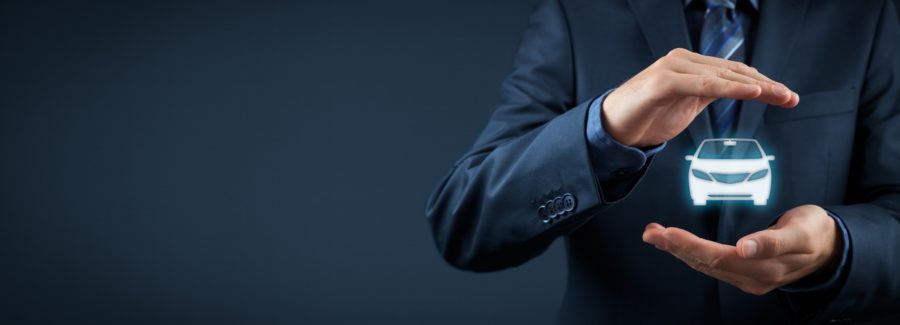 Car (automobile) insurance and collision damage waiver concepts. Businessman with protective gesture and icon of car.
