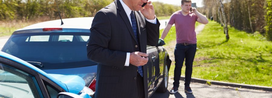 Businessman Making Phone Call After Traffic Accident