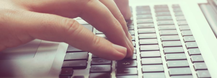 Close up of a man typing at the keyboard