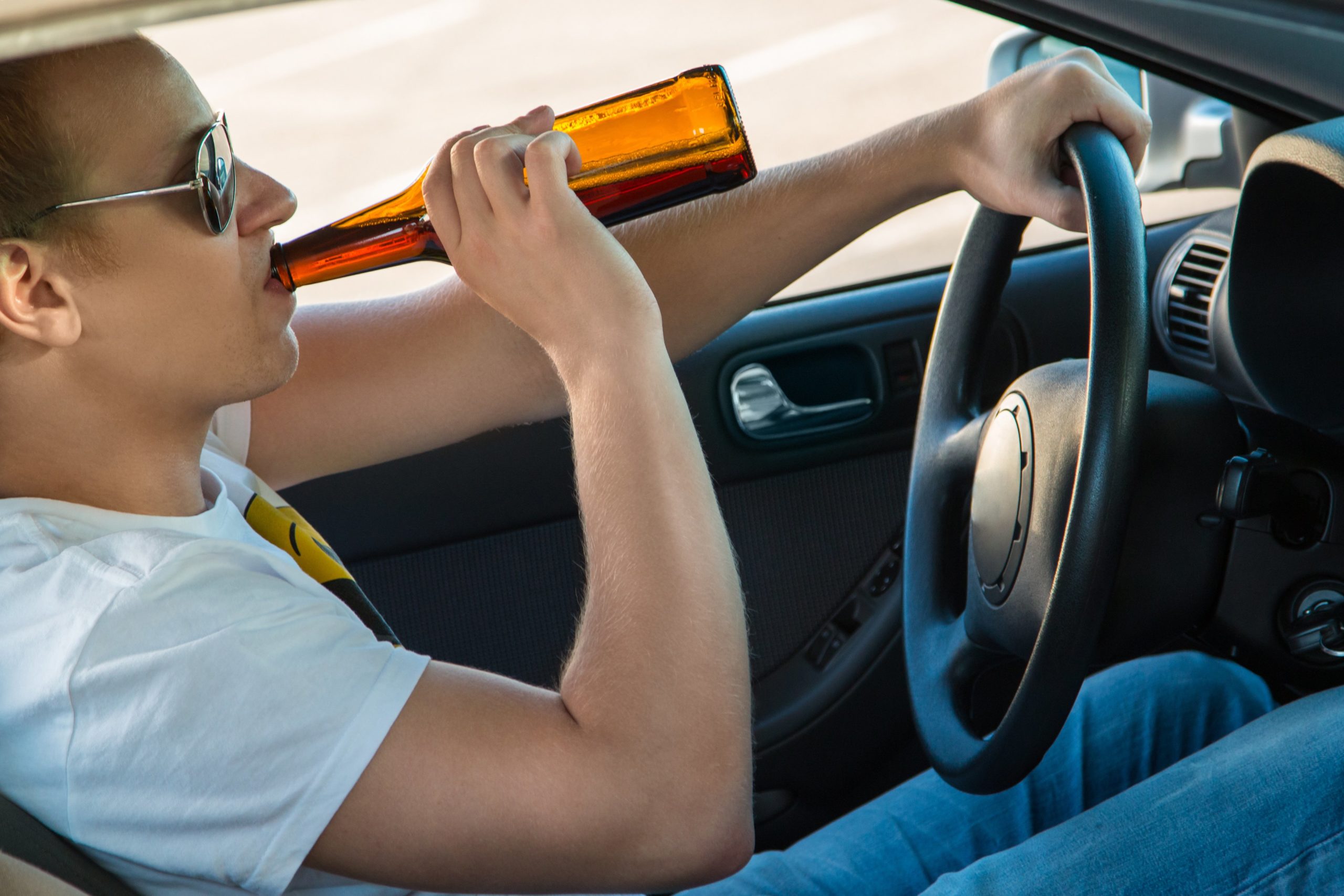 Man drinking beer while driving.