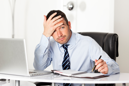 distressed-man-looking-a-papers-on-his-desk